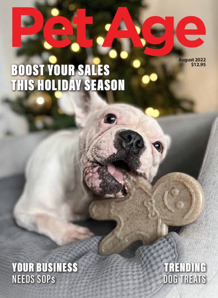 PetAge-August2022-Cover, Bull Dog chews gingerbread in front of a Christmas Tree