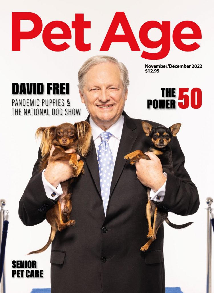 November Pet Age cover, man holding two puppies.